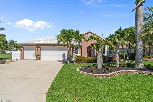 View of front of home featuring driveway, a garage, a front yard, and stucco siding | Image 10