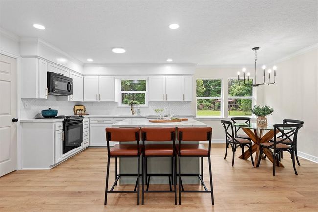 Spacious kitchen with island, recessed lighting, updated cabinetry, new back splash, and new faucets and cabinet hardware | Image 8
