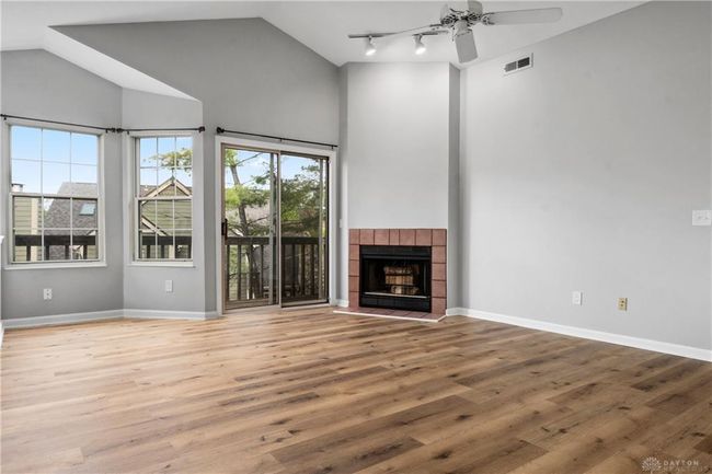 living room view with balcony and fireplace | Image 13