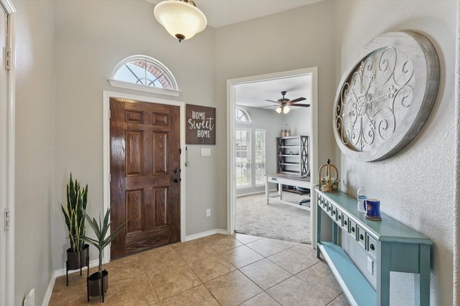 Foyer entrance featuring a wealth of natural light, baseboards, a ceiling fan, and light tile patterned flooring | Image 4