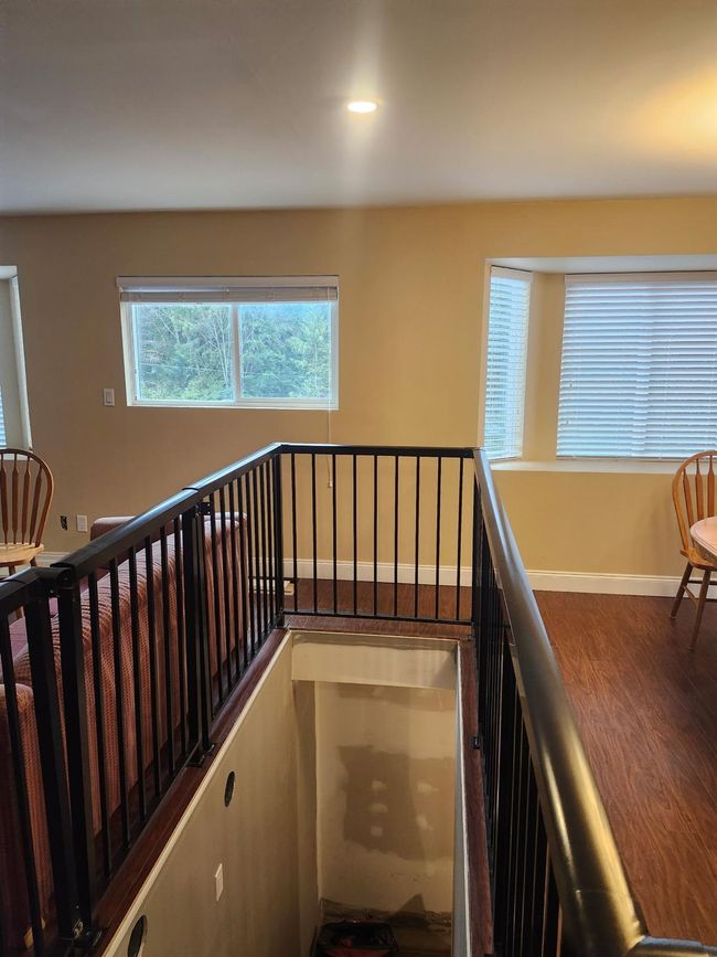 Stairs with wood finished floors and recessed lighting | Image 5
