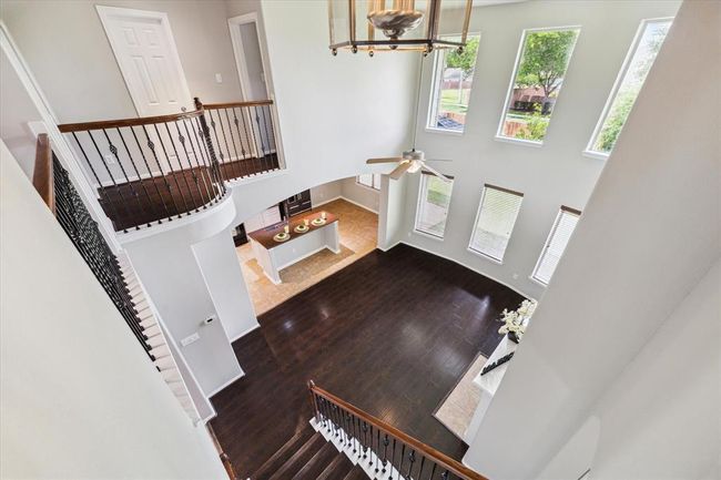Second floor view towards the living room and kitchen. | Image 36
