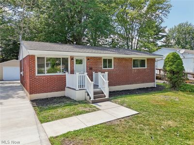 View of front of home with a garage and a front lawn and new concrete pathway to front porch | Image 3