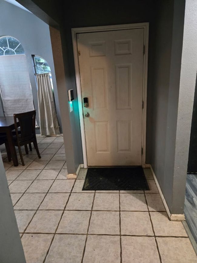 Entryway with light tile patterned floors and baseboards | Image 4