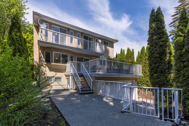 Back of property with a balcony, stucco siding, and stairway | Image 30
