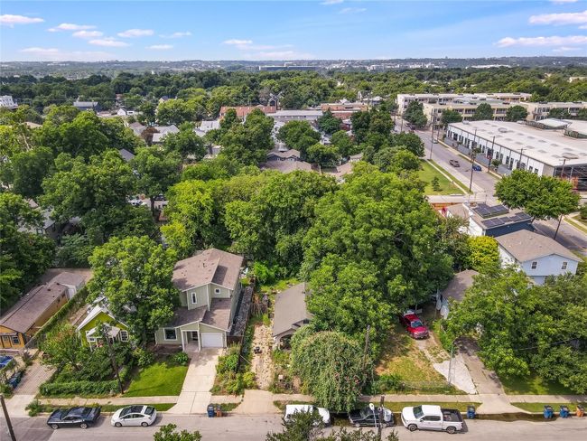 Aerial view of residential area featuring a tree filled landscape | Image 8