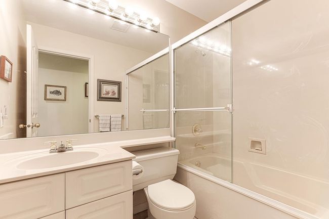 Bathroom with enclosed tub / shower combo, vanity, and toilet | Image 19