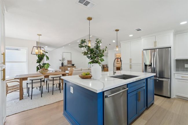 Another view of the kitchen as it opens up into the dining area. | Image 13