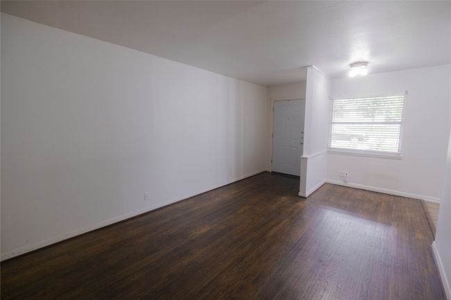 Spare room featuring dark wood-type flooring and baseboards | Image 4