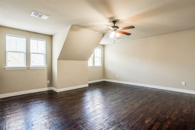 Additional living space with ceiling fan, dark wood-style flooring, and baseboards | Image 6