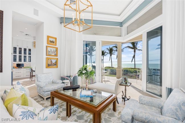 Living room located on second floor which is the main living level; pocketing sliders, spectacular Gulf sunset views | Image 11