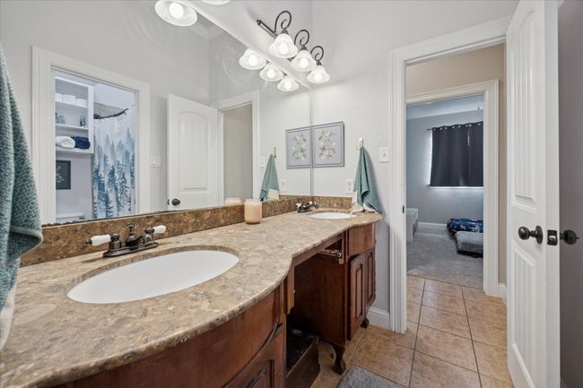 Guest bath with double vanity and marble counters | Image 17