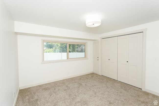 Unfurnished bedroom with carpet, a closet, and baseboards | Image 6