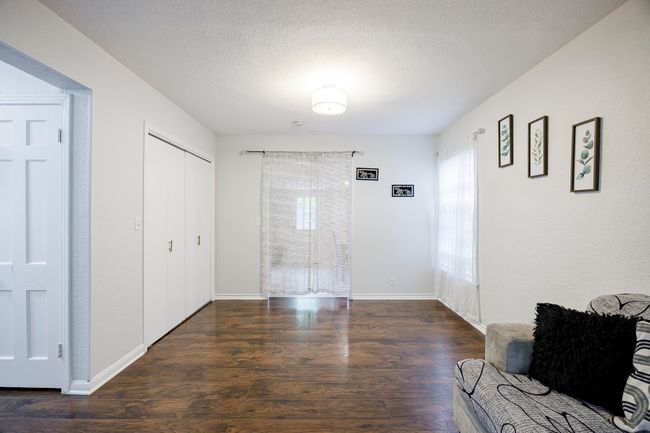 Entrance foyer featuring baseboards, wood finished floors, and a textured ceiling | Image 7