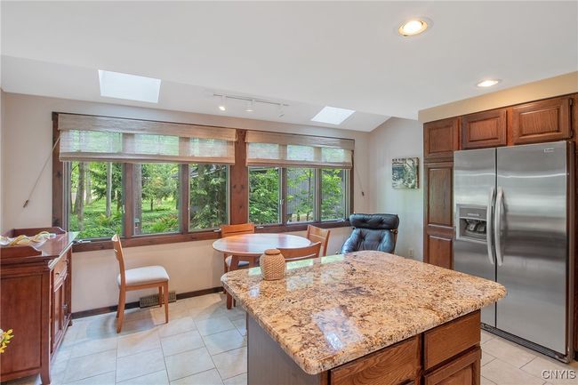 Relaxing eat in area with ample windows inviting in natural lighting | Image 14