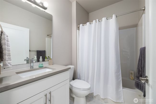 Main bath has taller cabinets with quartz counters & a taller toilet. | Image 7