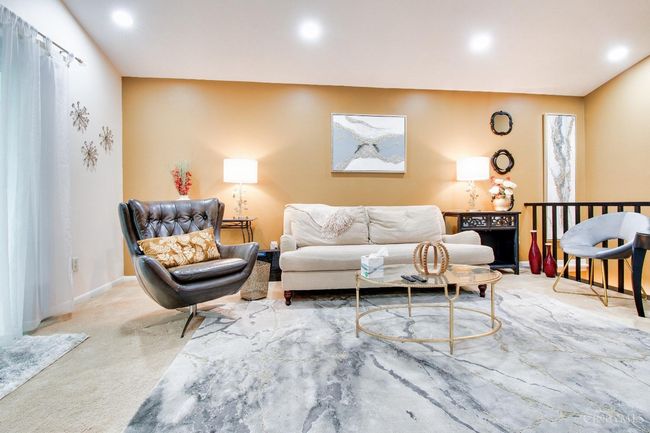 The living room is so comfortable and has a fireplace and walkout to the deck! | Image 4