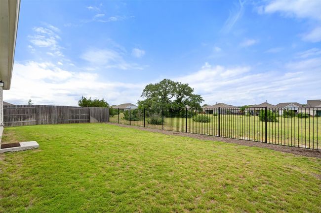 Enjoy the spacious backyard with dedicated green space behind. | Image 31