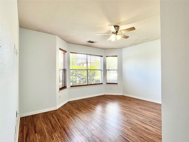 Unfurnished room featuring ceiling fan and wood finished floors | Image 23