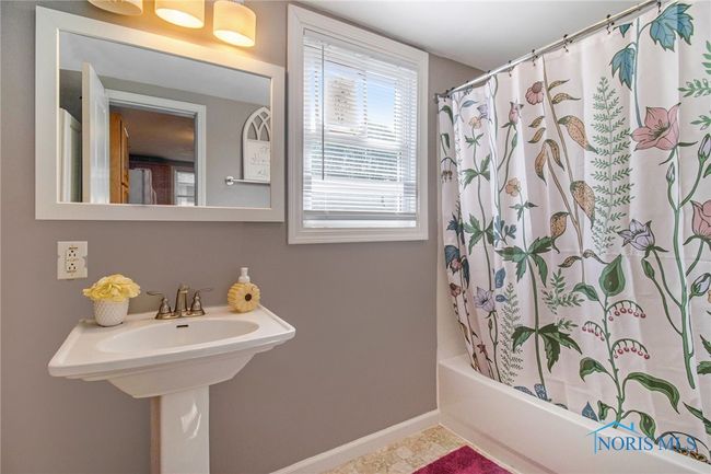The bathroom has been thoughtfully updated with fresh finishes and a clean, modern look. | Image 13