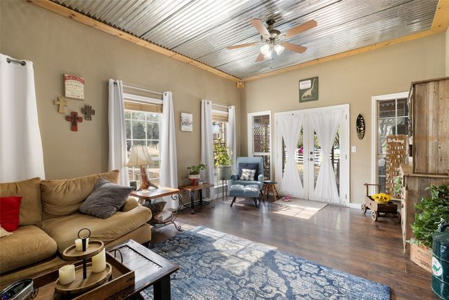 Living room featuring ceiling fan and wood finished floors | Image 15