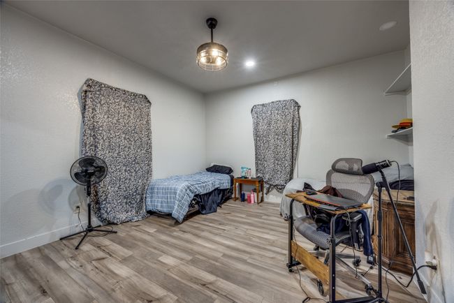 Bedroom featuring wood finished floors and recessed lighting | Image 5