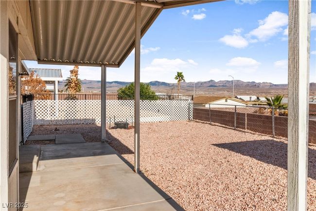 View of yard featuring a fenced backyard, a mountain view, and a patio | Image 35