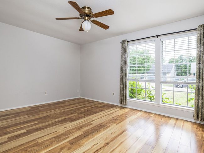 Empty room with hardwood / wood-style flooring and ceiling fan | Image 11