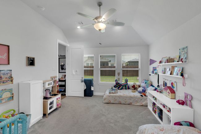 Carpeted bedroom featuring vaulted ceiling, a ceiling fan, recessed lighting, and ensuite bathroom | Image 15