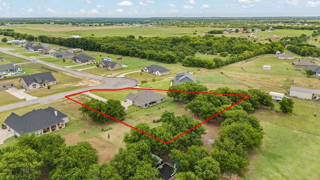 Aerial view of sparsely populated area with property parcel outlined and nearby suburban area | Image 40