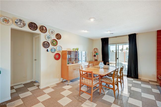 Dining space featuring light floors, baseboards, and a textured ceiling | Image 10