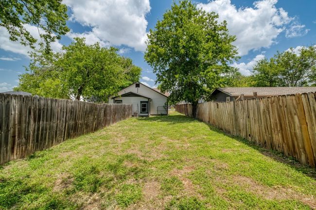 View of fenced backyard | Image 23