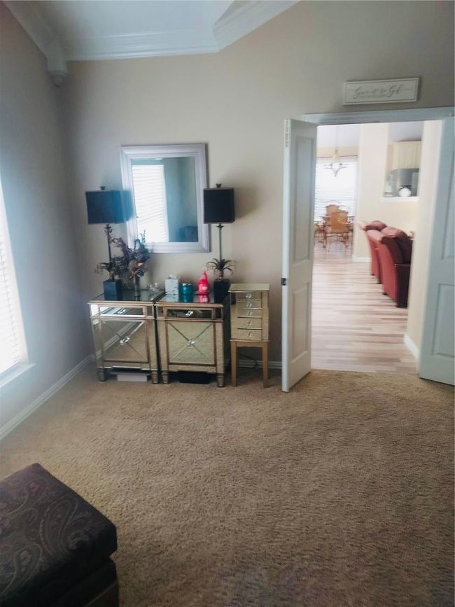 Owner's Ensuite features a huge bedroom with crown molding. | Image 25