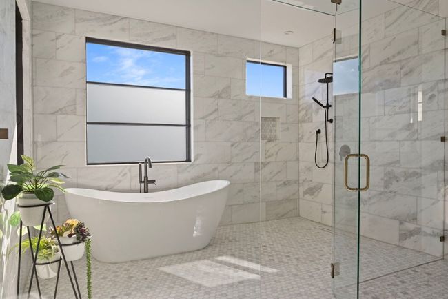 Full bathroom with a freestanding tub and a shower stall | Image 19