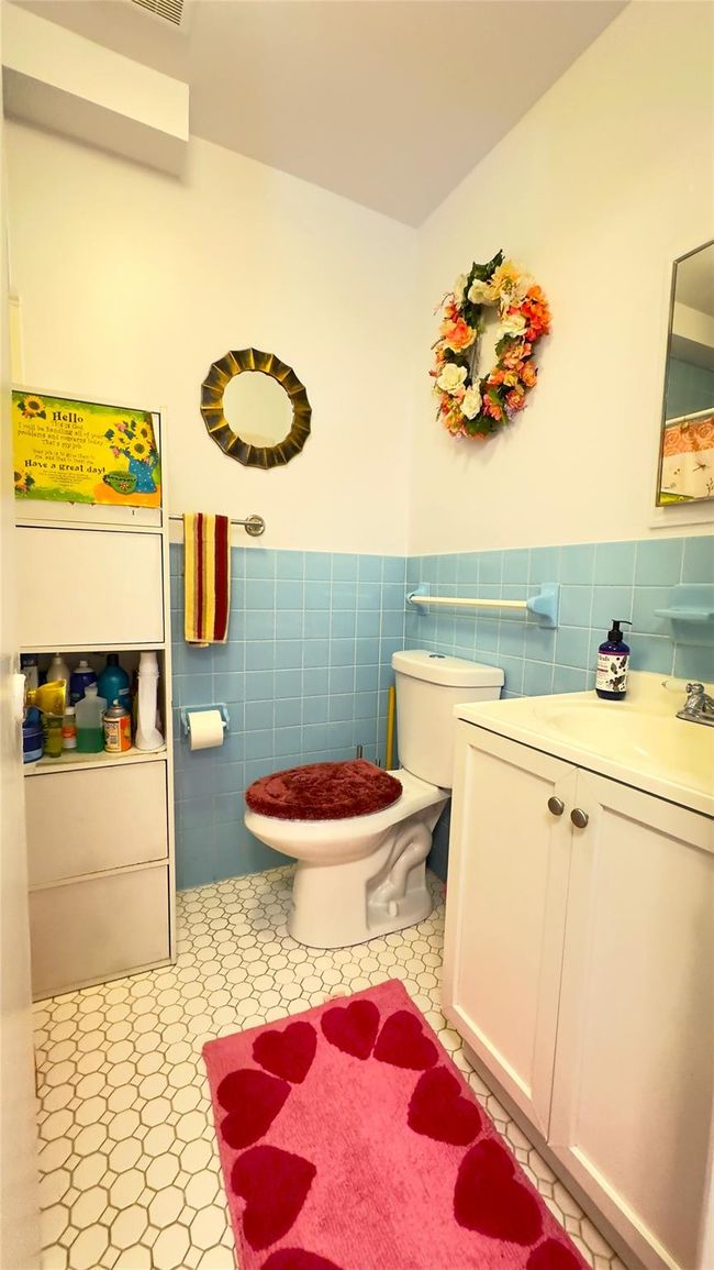 Full bathroom with Tub. Featuring tile walls, vanity, tiled floors, new Toilet. | Image 10