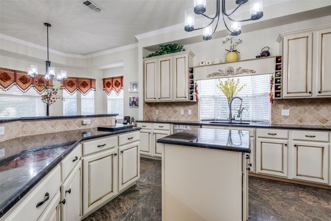 Kitchen features granite counters and an abundance of custom cabinetry. | Image 14