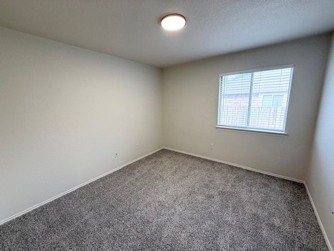 Carpeted empty room featuring baseboards | Image 7