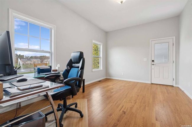 Home office featuring light wood-style flooring and baseboards | Image 9