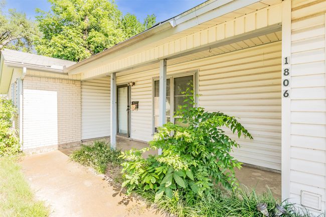 Property entrance with brick siding and covered porch | Image 4