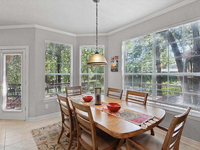 Dining space with plenty of natural light, light tile patterned floors, and crown molding | Image 14