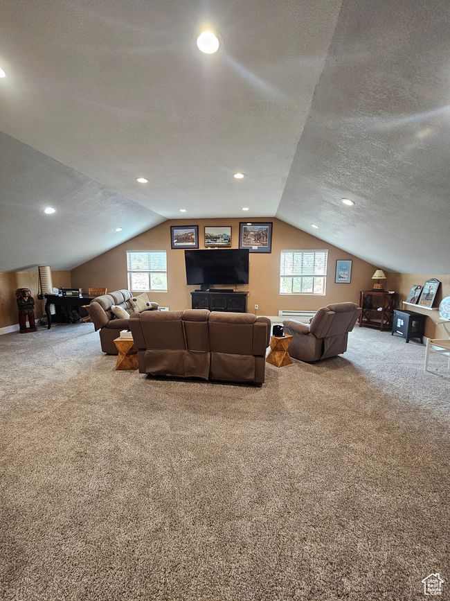 Upstairs living room featuring a healthy amount of sunlight and lofted ceiling | Image 47