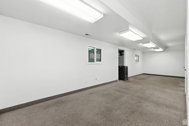 Spare room featuring carpet floors and baseboards | Image 14