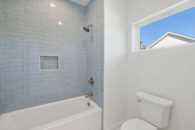 Bathroom with toilet, baseboards, and shower / bathing tub combination | Image 19