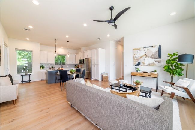 Living room with light wood-style flooring, recessed lighting, and a ceiling fan | Image 7