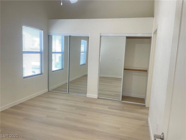 Unfurnished bedroom featuring two closets and light wood-style flooring | Image 20