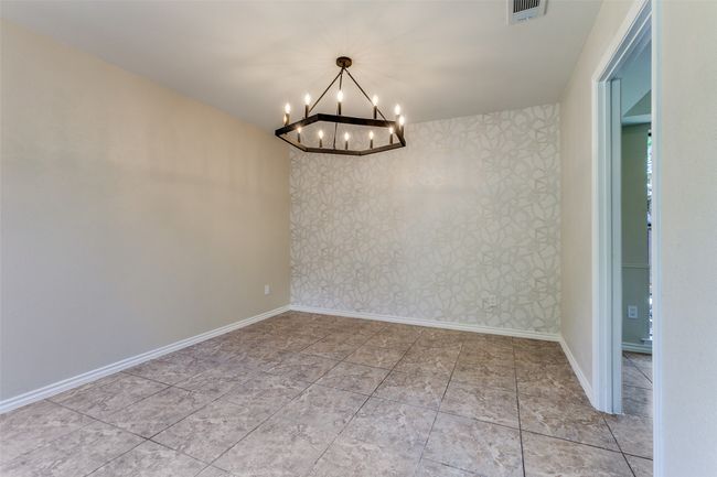 Empty room with a chandelier and baseboards | Image 27