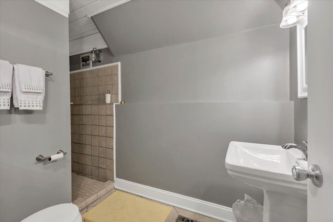 Bathroom featuring tiled shower and toilet | Image 26