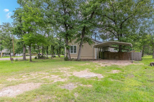 View of yard featuring fence and a carport | Image 23