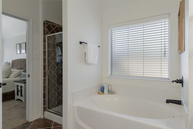 Full bath featuring a garden tub, a shower stall, and tile patterned floors | Image 22