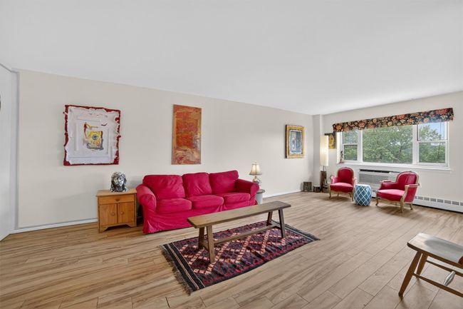 Living room with wood finished floors and baseboards | Image 9